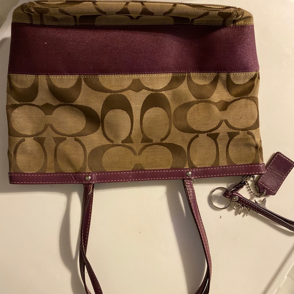 Medium tan and plum coach bag.